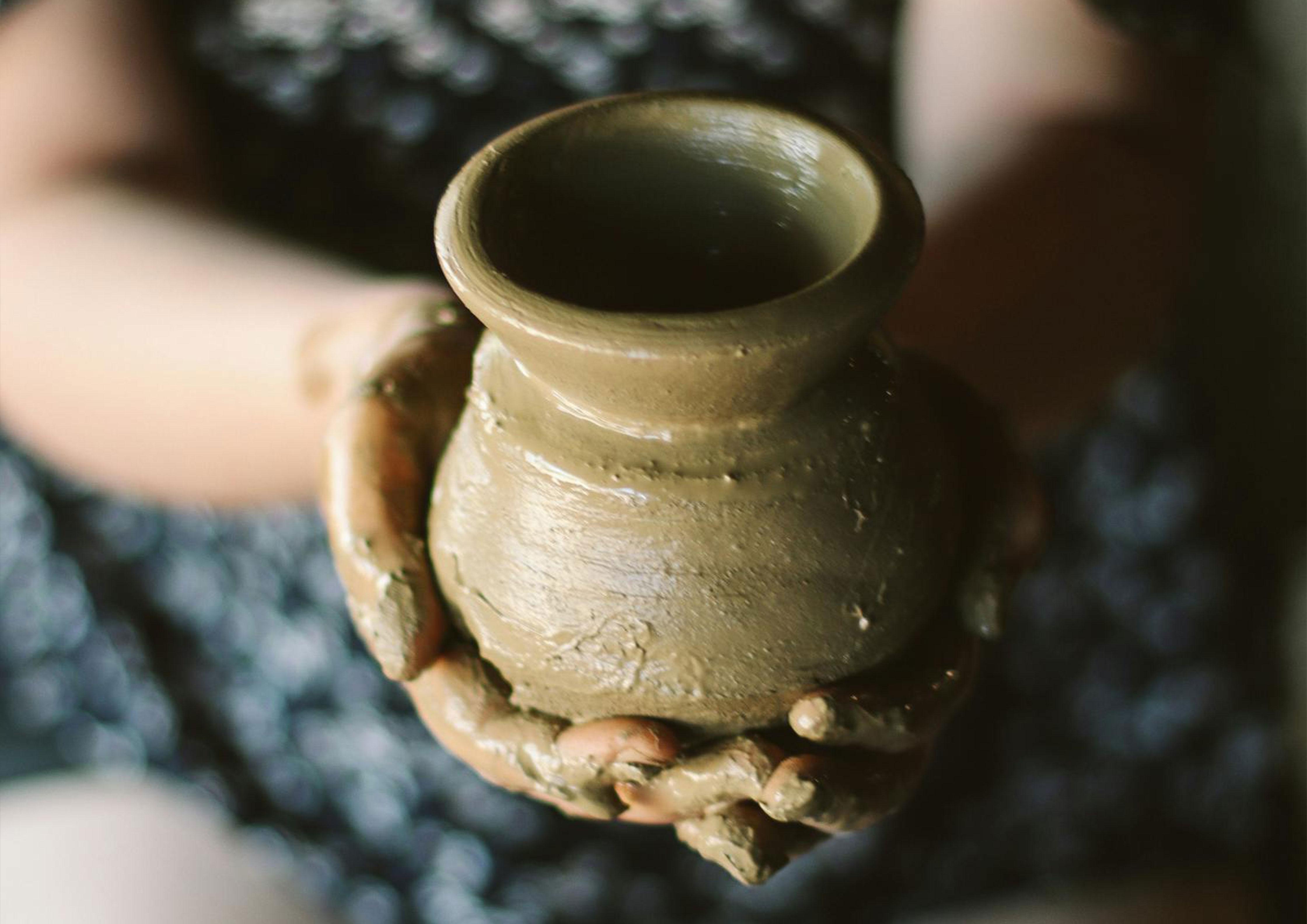 hands holding pottery creation